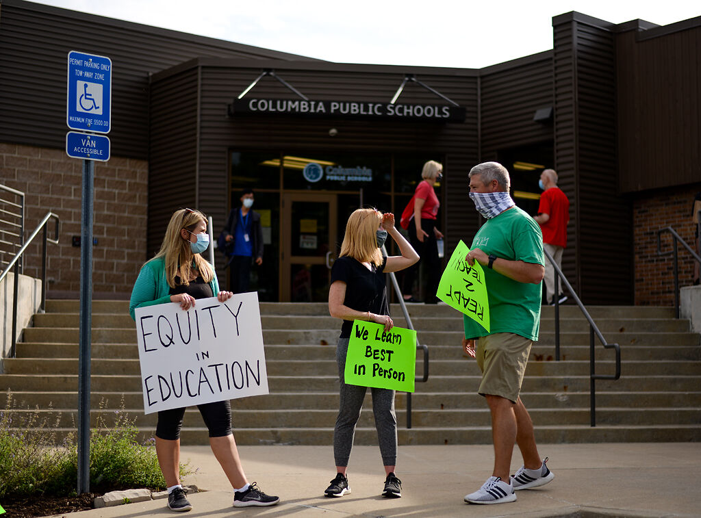 Rally attendees Tuesday wait outside for the Columbia School Board meeting
